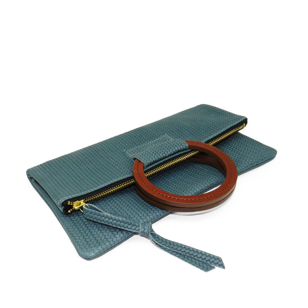 jolie clutch with handmade leather handles in ocean woven leather